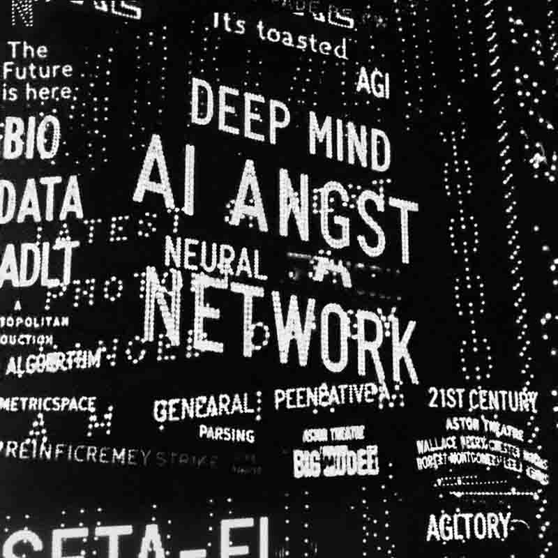 A black and white collage of text in a dot-matrix or digital display style. The most prominent words, capitalized in the center, are DEEP MIND, AI ANGST, and NEURAL NETWORK. Surrounding them are other technology-related terms like The Future is here:, AGI, ALGORITHM, and BIO DATA, creating a dense and overwhelming visual.
